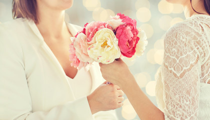 close up of happy lesbian couple with flowers