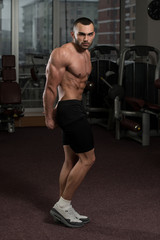 Naklejka na ściany i meble Man In Gym Showing His Well Trained Body