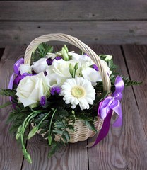 Bouquet of white  eustoma, roses and chrysanthemums in basket