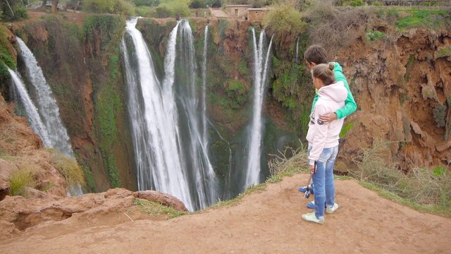 Woman and man looking waterfall. Filmed in Morocco near Ouzoud waterfall