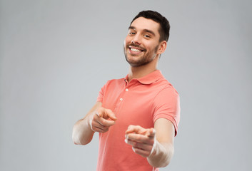 man pointing finger to you over gray background