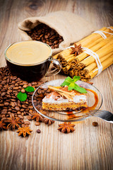 Cup of coffee and dessert on wooden background