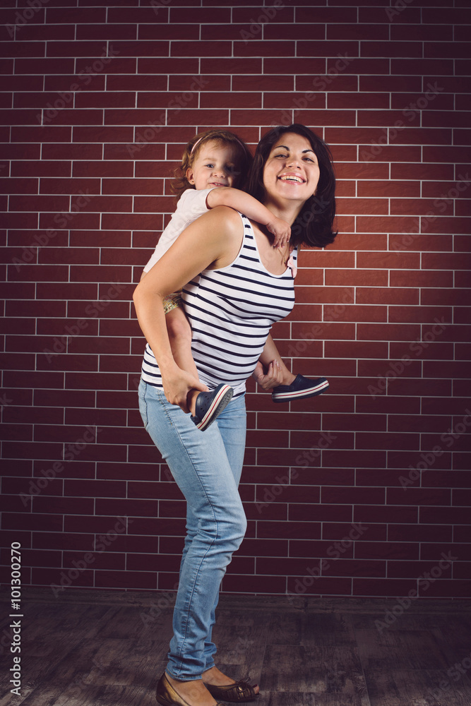 Wall mural girl on mother's back at studio