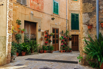 Typical balearic flowered house entrances, facade with pots, plants and flowers at Valldemossa, Mallorca, Spain.