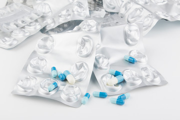 medicine pills and empty packets of prescription