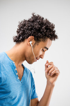 handsome young man listens to music and dances