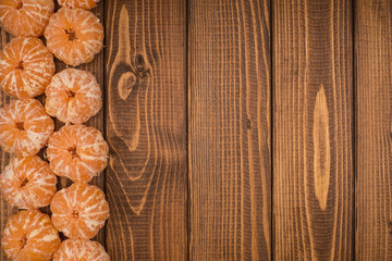 Peeled tangerine on a wooden table. Copy space.