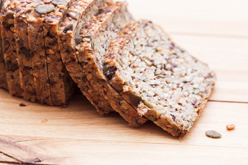 Wholemeal, wholewheat bread on wooden table. Organic, healthy food