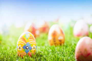 Colorful hand painted Easter eggs in grass. Spring theme