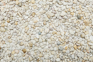 Small naturally polished white rock pebbles background