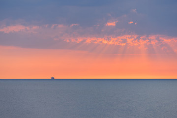 Obraz premium Cruise ship on a open sea during a sunset.
