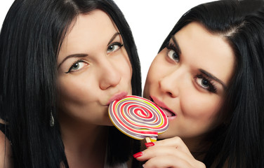 Funny lesbian couple with lollipop