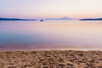 Yacht and blue water ocean with Athos mountain in the background - Greece, Europe