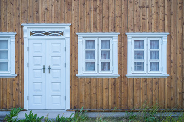 Detail view of wooden scandinavian house with doors and windows.