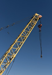 Yellow construction crane and blue sky.