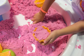 kid playing kinetic sand