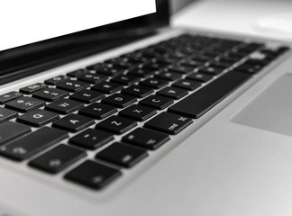 Laptop keyboard on wooden white table