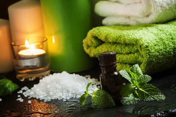 Peppermint essential oil in a Spa concept with towel, sea salt,