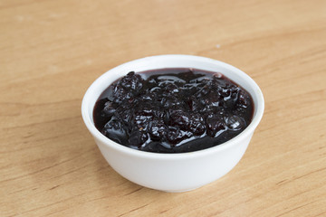 White plate with jam on the table