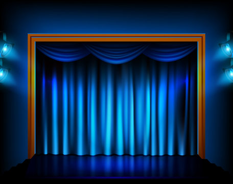 Theater stage with blue curtains and spotlights.