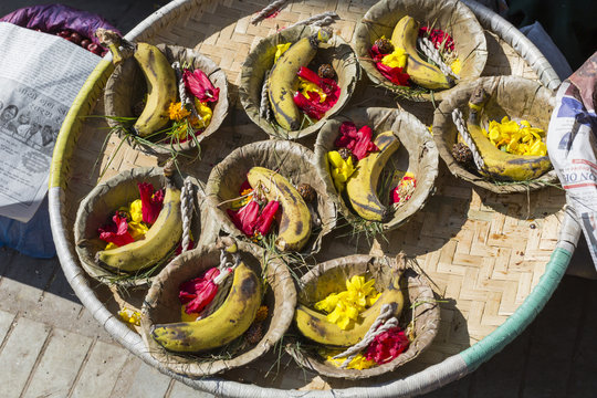 Bowls with saffron water and flowers at Bodhnath stupa in Kathma
