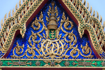 Fototapeta premium Traditional Thai style Stucco & Naga, Wood Carving Tympanum of Thai Roof Temple at Wat Benchamabopit Dusitvanaram in Bangkok, Thailand