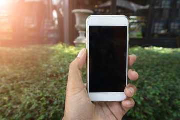 Man's hand shows mobile smartphone in vertical position