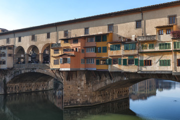 Fototapeta na wymiar Ponte Vecchio a medieval stone arch bridge over the Arno river, noted for having shops built along it, as was once common; Florence, Italy. 