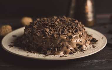 Chocolate cake on the dark rustic background. Shallow depth of field. Toned image.