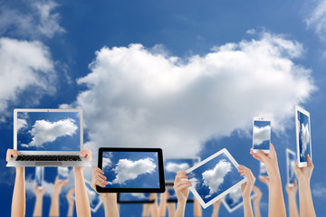 Hands holding electronic gadgets with sky on screens. Cloud computing concept
