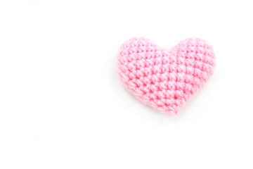 Heart made from yarn on a white background.