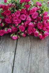 Pink roses on a wooden table