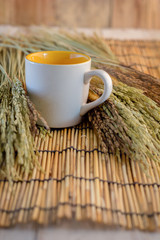 coffee cup with wheat ears on bamboo mat