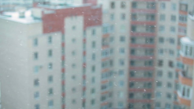 Blizzard with snowflakes and buildings backround
