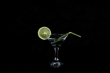 slice of llime water and a glass with a cocktail