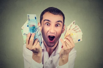 Fotobehang happy young man with money euro banknotes ecstatic celebrates success © pathdoc