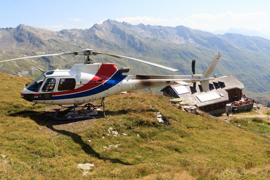 Transport Helicopter Landed Near Alpine Hut And Mountain Panorama In Hohe Tauern Alps, Austria