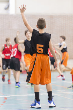 children playing a basketball game in a competition
