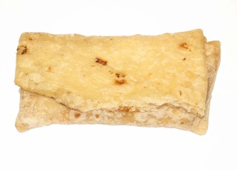 Cooked beef and bean burrito on white background.