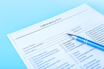 Fototapeta na wymiar Laboratory test list with pen on blue background, close up