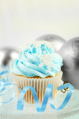 Tasty blue cupcake with decorations, closeup