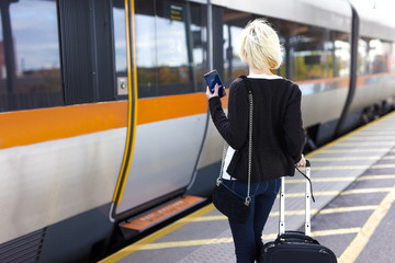 Traveling woman at a outdoor train station terminal