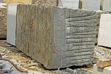 Huge Indian granite blocks stacked for stone processing such as cutting and polishing into flooring...