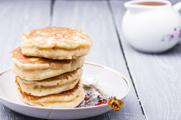 stack of hot pancakes with buckthorn syrup