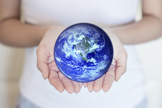 Hands holding a blue earth, save earth concept