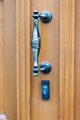 Door Handle / Wooden door with a handle and a lock