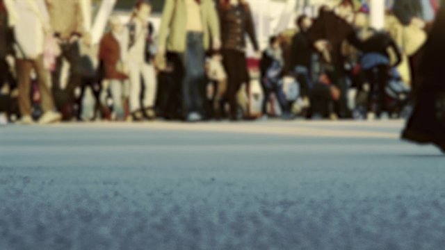 Defocused crowd of people walking in the city