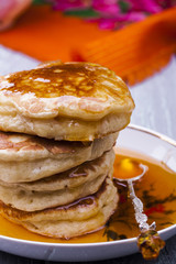 stack of hot pancakes with buckthorn syrup