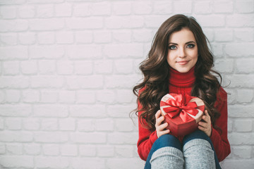 Cute woman with a gift heart.