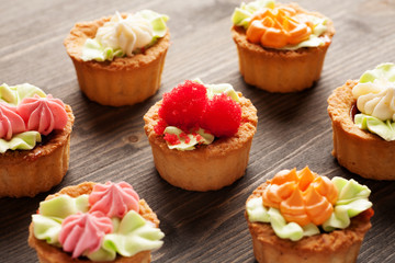 Cake basket with cream on a wooden table